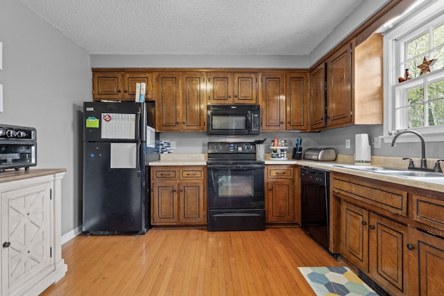 740 Acorn Dr, Clarksville, TN 37043 - kitchen with a sink, brown cabinetry, and black appliances