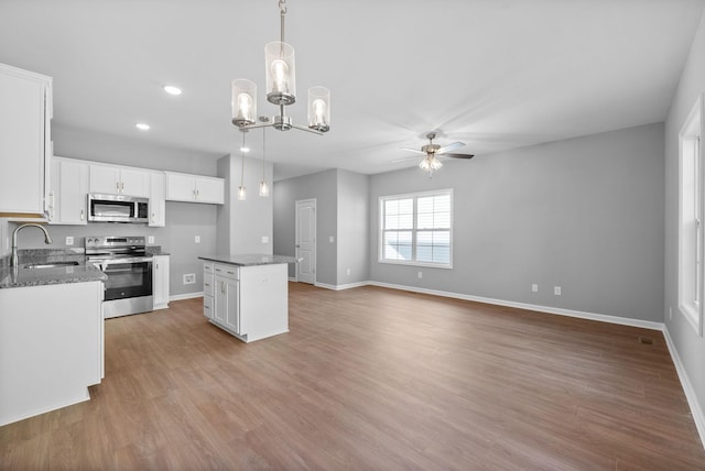 837 Cumberland Dr, Clarksville, TN 37040 - kitchen featuring a sink, ceiling fan with notable chandelier, stainless steel appliances, baseboards, and white cabinetry