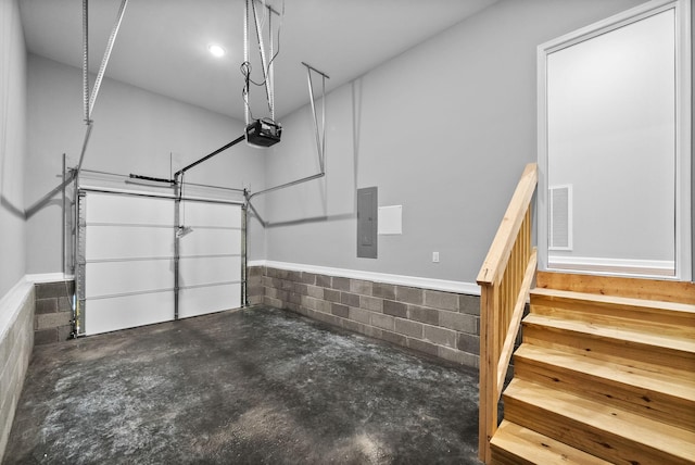 837 Cumberland Dr, Clarksville, TN 37040 - garage featuring visible vents, a garage door opener, electric panel, and concrete block wall