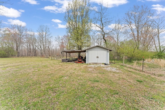 view of yard with an outdoor structure, a carport, and fence