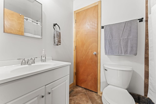 bathroom featuring tile patterned floors, toilet, and vanity