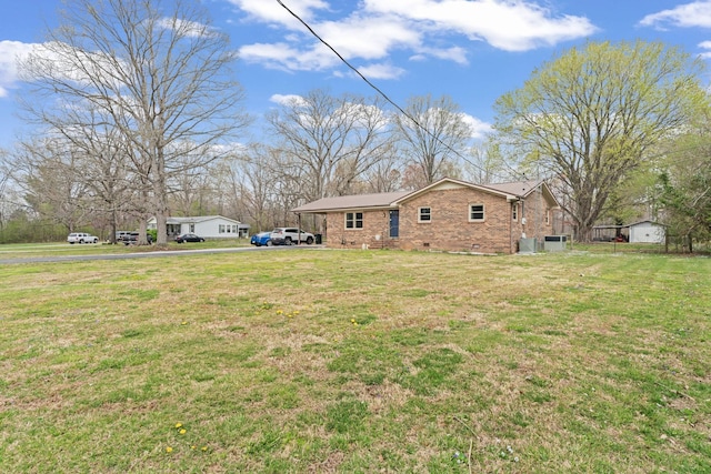 view of side of property with a lawn and brick siding