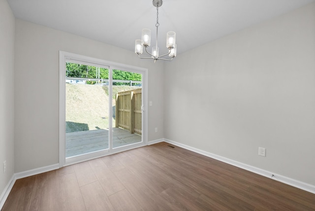 839 Cumberland Dr, Clarksville, TN 37040 - empty room featuring baseboards, visible vents, wood finished floors, and a chandelier