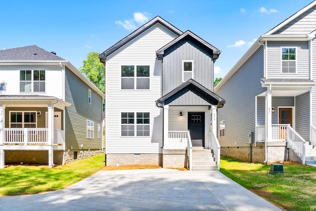 839 Cumberland Dr, Clarksville, TN 37040 - view of front facade featuring a front yard, board and batten siding, covered porch, and crawl space