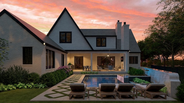 1352 Duncanwood Ct, Nashville, TN 37204 - back of property featuring a chimney, an outdoor pool, and a patio area