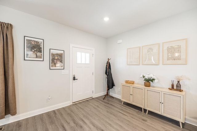 entrance foyer featuring baseboards and light wood-style floors