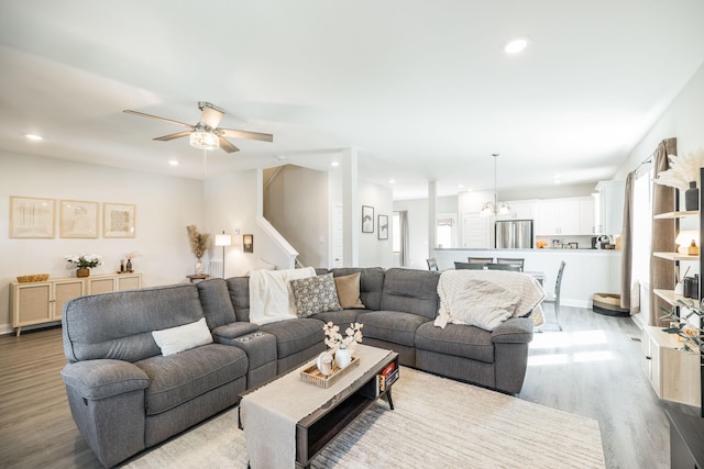 living room with stairs, recessed lighting, ceiling fan, and light wood-type flooring