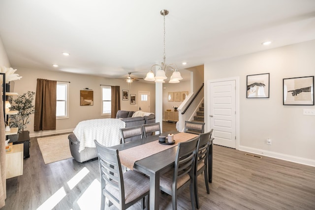 dining space with light wood finished floors, baseboards, stairway, and recessed lighting