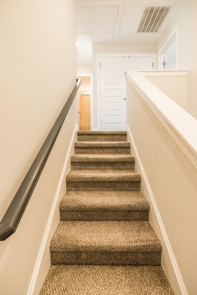 stairs with attic access and visible vents