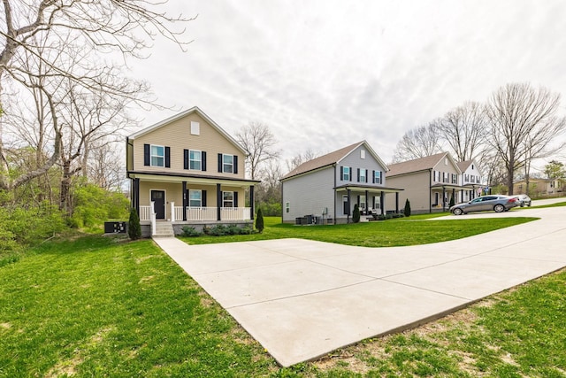 traditional-style house featuring a porch and a front lawn