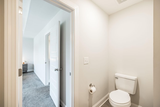 bathroom with baseboards and toilet