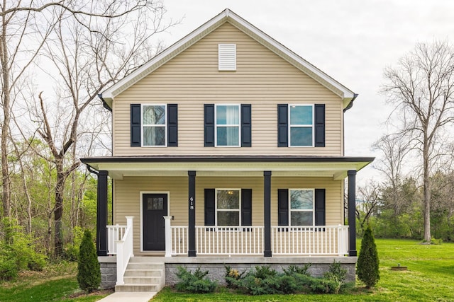 view of front of house featuring a front lawn and covered porch