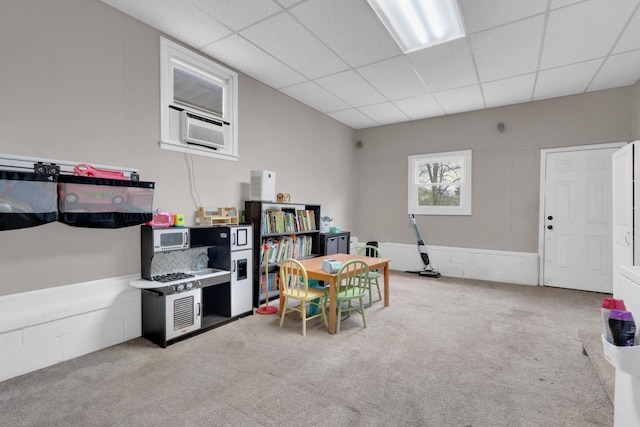 kitchen featuring carpet floors, cooling unit, and a paneled ceiling