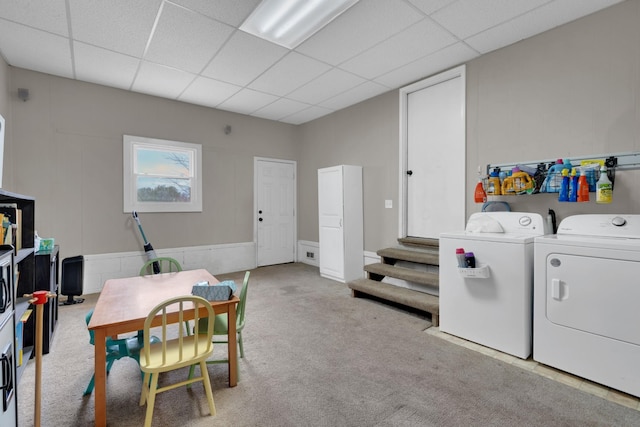 interior space featuring carpet flooring, washing machine and dryer, and a paneled ceiling
