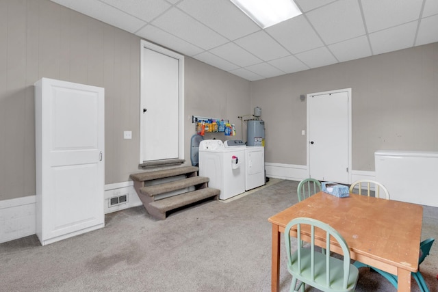 interior space with visible vents, a drop ceiling, and separate washer and dryer