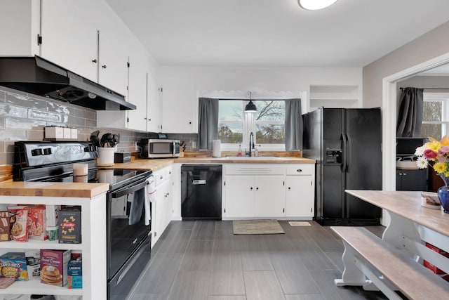 kitchen featuring a sink, under cabinet range hood, white cabinetry, and black appliances