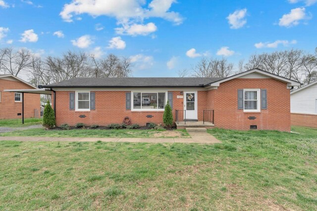 ranch-style house featuring brick siding, a front lawn, crawl space, and roof with shingles