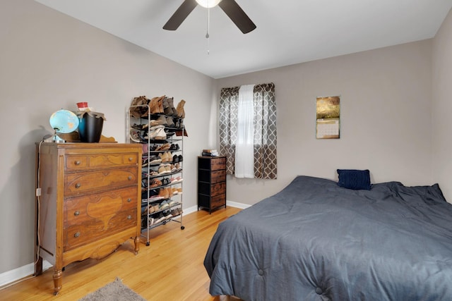 bedroom with baseboards, wood finished floors, and ceiling fan