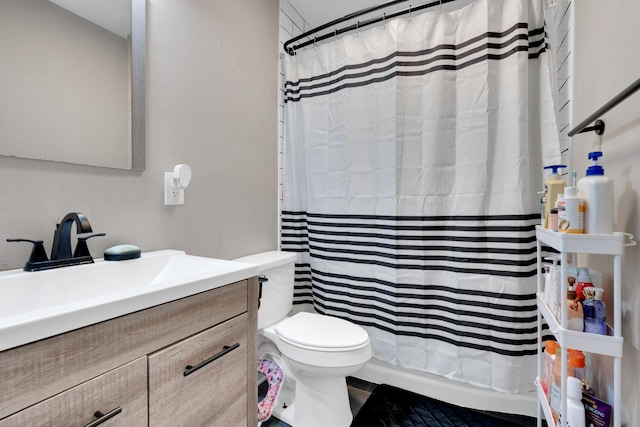 bathroom featuring a shower with curtain, toilet, and vanity