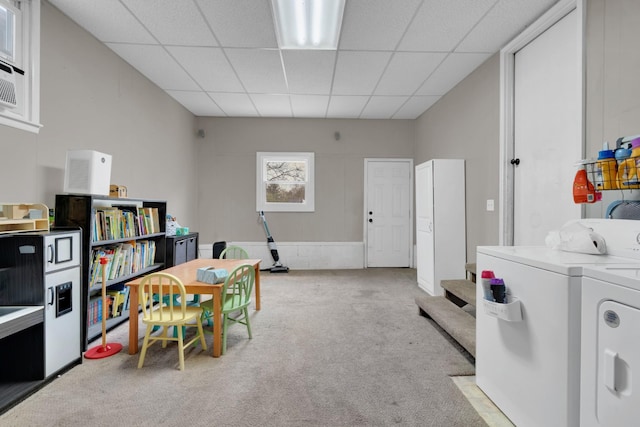 home office featuring a drop ceiling, carpet floors, and washer and dryer