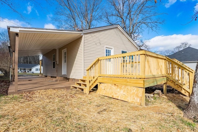 view of property exterior with stairway and a wooden deck