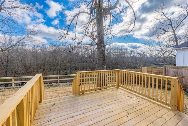 deck featuring fence and a forest view