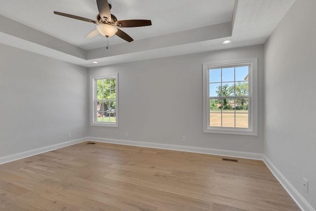 spare room with light wood-type flooring, baseboards, recessed lighting, a ceiling fan, and visible vents