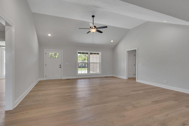 unfurnished living room with light wood finished floors, baseboards, a ceiling fan, and vaulted ceiling
