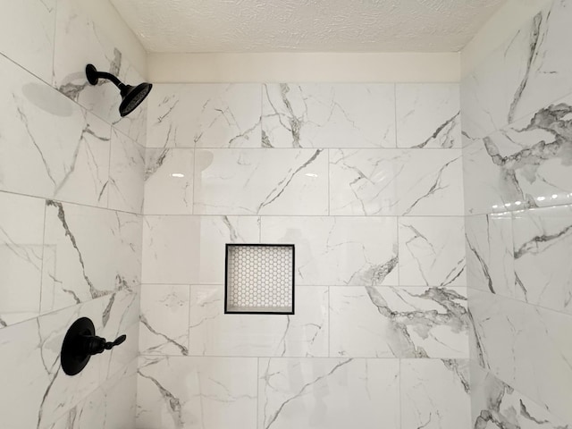 details featuring a tile shower and a textured ceiling