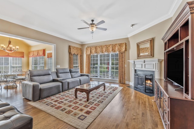 1531 Pumpkin Ridge Ct, Nolensville, TN 37135 - living area with a fireplace with flush hearth, ceiling fan with notable chandelier, wood finished floors, and a wealth of natural light