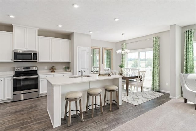 1169 Savannah Ave, Gallatin, TN 37066 - kitchen featuring stainless steel appliances, a sink, dark wood-style floors, white cabinets, and recessed lighting