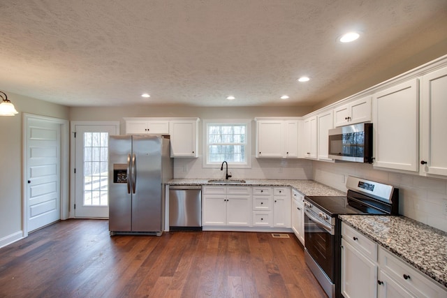 kitchen featuring a sink, white cabinetry, and stainless steel appliances