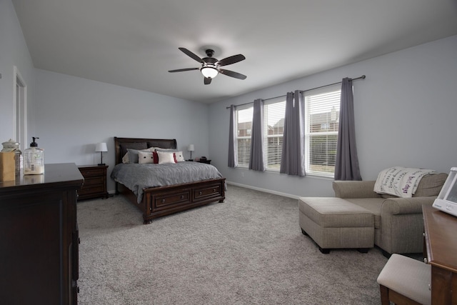 carpeted bedroom featuring baseboards and a ceiling fan
