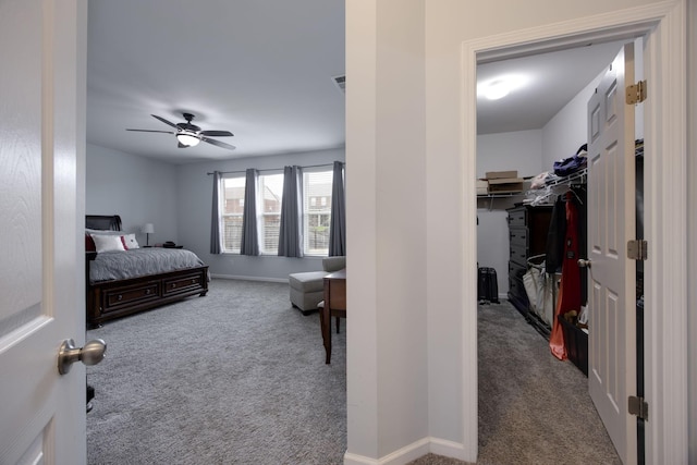 bedroom with baseboards, a spacious closet, visible vents, and carpet floors