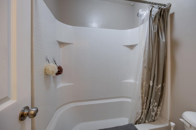 bathroom with shower / bathtub combination with curtain and toilet
