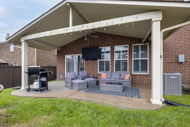 back of house featuring outdoor lounge area, fence, cooling unit, a patio, and brick siding