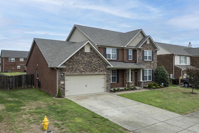 craftsman inspired home featuring a front yard, a shingled roof, a garage, fence, and driveway