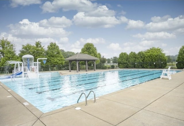 community pool featuring a patio and a gazebo