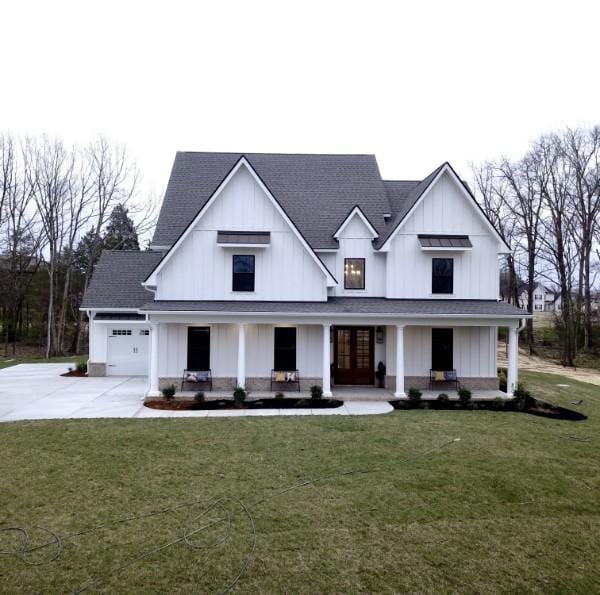 6930 Twelve Corners Rd, Lascassas, TN 37085 - modern farmhouse style home featuring a front lawn, driveway, board and batten siding, covered porch, and french doors