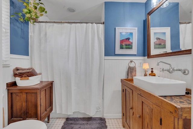 4337 Morriswood Dr, Nashville, TN 37204 - bathroom with tile patterned floors, wainscoting, vanity, toilet, and a shower with shower curtain