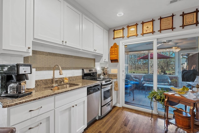 4337 Morriswood Dr, Nashville, TN 37204 - kitchen featuring stainless steel appliances, a sink, white cabinets, tasteful backsplash, and recessed lighting