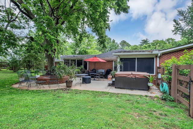 4337 Morriswood Dr, Nashville, TN 37204 - back of property featuring a hot tub, a patio area, a lawn, and brick siding