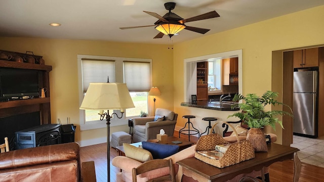 1385 Mitchell St, Celina, TN 38551 - living room featuring a wood stove, recessed lighting, a ceiling fan, and light wood finished floors