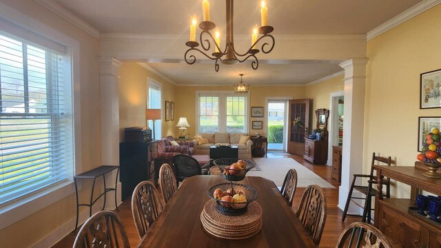 1385 Mitchell St, Celina, TN 38551 - dining room with decorative columns, wood finished floors, an inviting chandelier, and crown molding