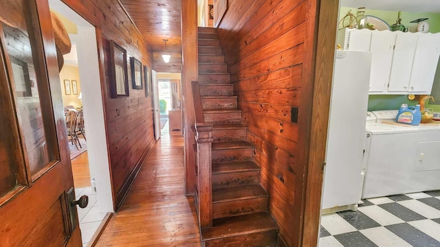 1385 Mitchell St, Celina, TN 38551 - corridor with washer and clothes dryer, stairs, wood ceiling, wood walls, and light floors
