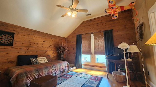 1385 Mitchell St, Celina, TN 38551 - bedroom with visible vents, wooden walls, wood finished floors, a baseboard heating unit, and vaulted ceiling