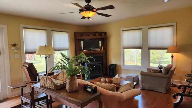 1385 Mitchell St, Celina, TN 38551 - living room with baseboards, ceiling fan, wood finished floors, and a wood stove