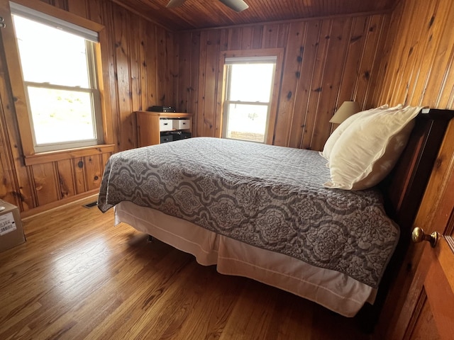764 Cedar Hill Rd, Celina, TN 38551 - bedroom featuring baseboards, wooden walls, visible vents, wood ceiling, and wood finished floors