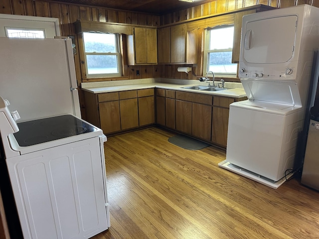 764 Cedar Hill Rd, Celina, TN 38551 - kitchen featuring white appliances, light countertops, light wood-style floors, brown cabinetry, and a sink