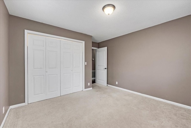 unfurnished bedroom with light carpet and baseboards